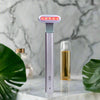 Light therapy face wand on a marble surface with plants and bottles in the background